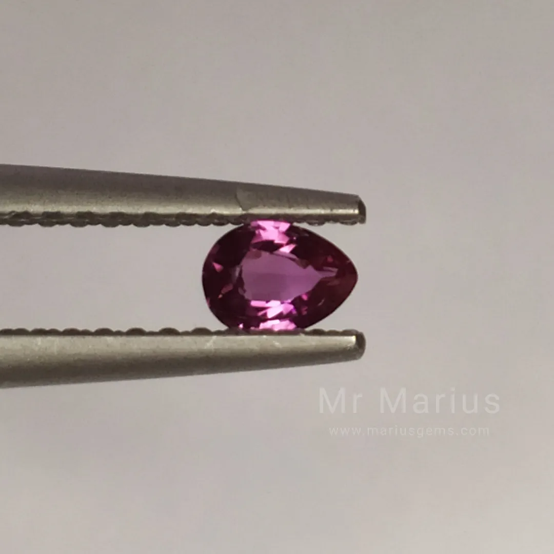 Small unheated redish purple sapphire, pears shaped cut.