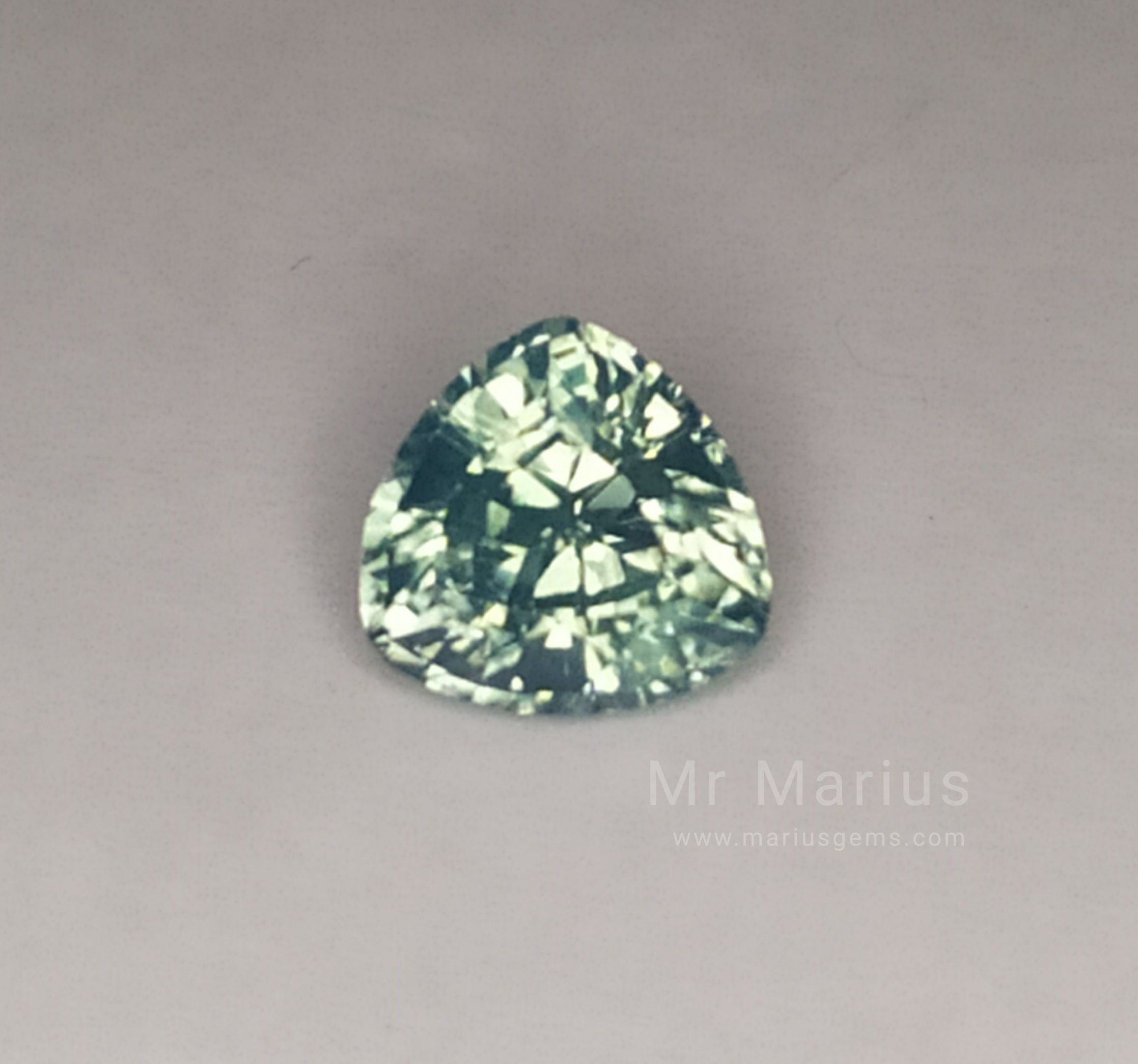Milky mint green triangular cut zircon.