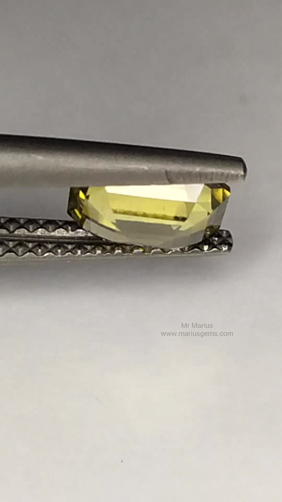 Thumbnail: Yellowish green "golden" zircon, octagon cut. Good glow in this one. Rotating.