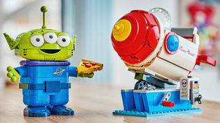 Official LEGO Disney 43307 Alien with Pizza Planet Rocket Ride set showing brick-built alien and arcade rocket ride