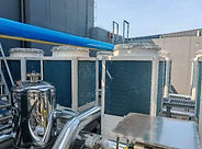 PLC-based HVAC control panel with HMI display for monitoring and controlling ventilation, pumps, and HVAC equipment.