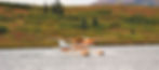 A floatplane landing on the lake and approaches the lodge to pick up guests and fly back to Talkeetna.