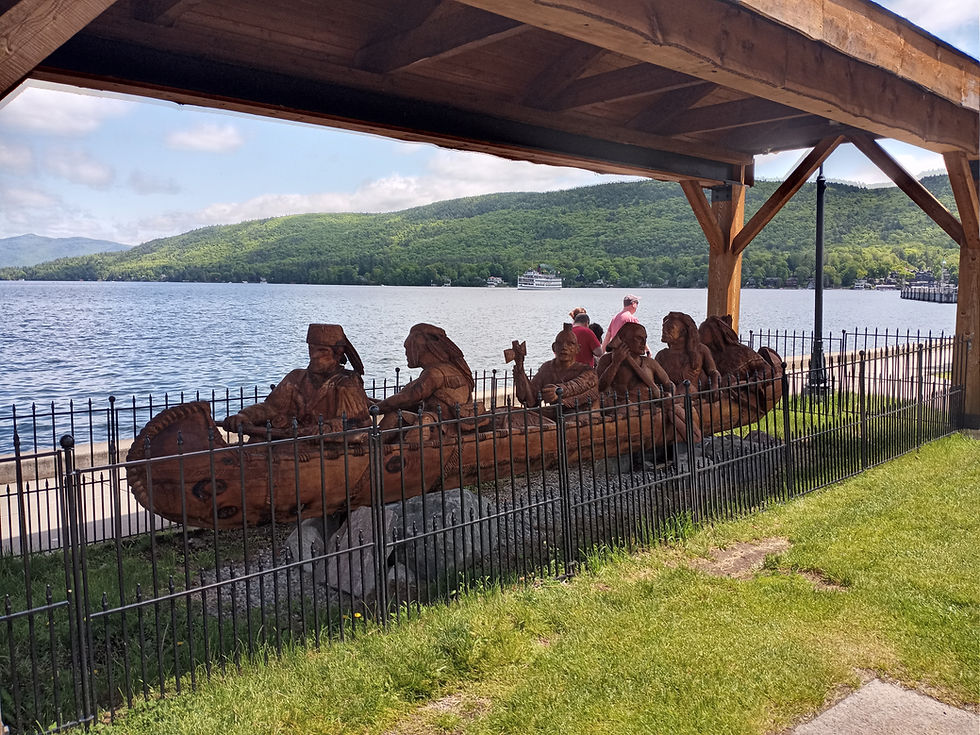 A wood carving depicting Robert Rogers in his men aboard a Canoe on display on the waterfront of Lake George Village. Photo from Tim Dusablon.