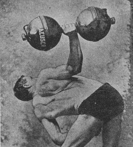 A figure bent to the side at the hips, with one hand supporting on the knee and the other holding a huge dumbell, pressing it upwards at 90 degrees to the torso