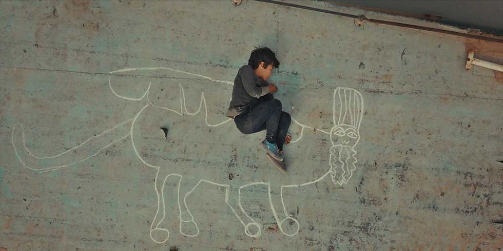Child pretends to ride a chalk-drawn creature on a concrete wall, mixing reality with imagination. The wall is weathered and textured.