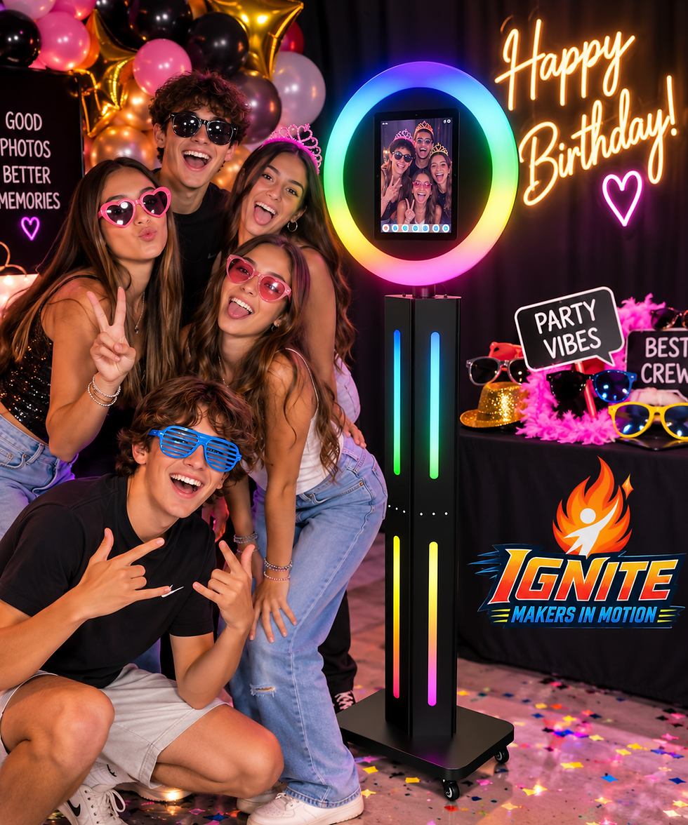 Group of teens posing around a colorful photo booth with neon lights and Ignite Makers in Motion logo