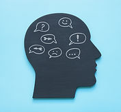 Head shape with speech bubbles representing dissociation and internal family systems