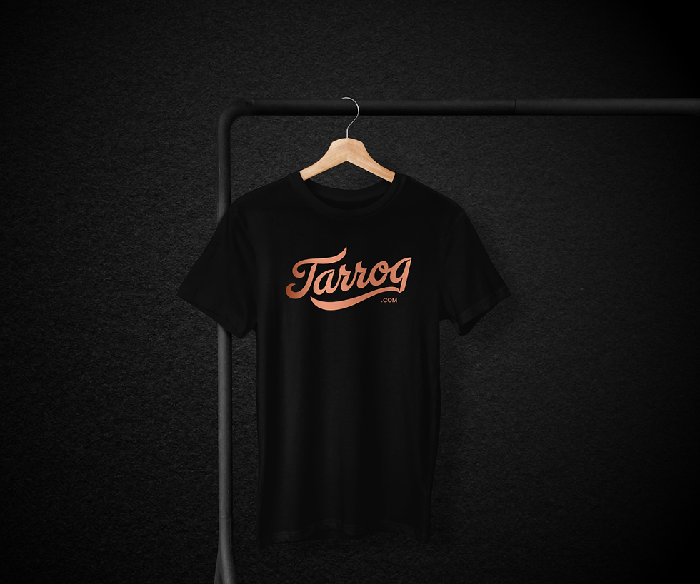A black t - shirt hanging on a hanger with Tarroq's logo in front.