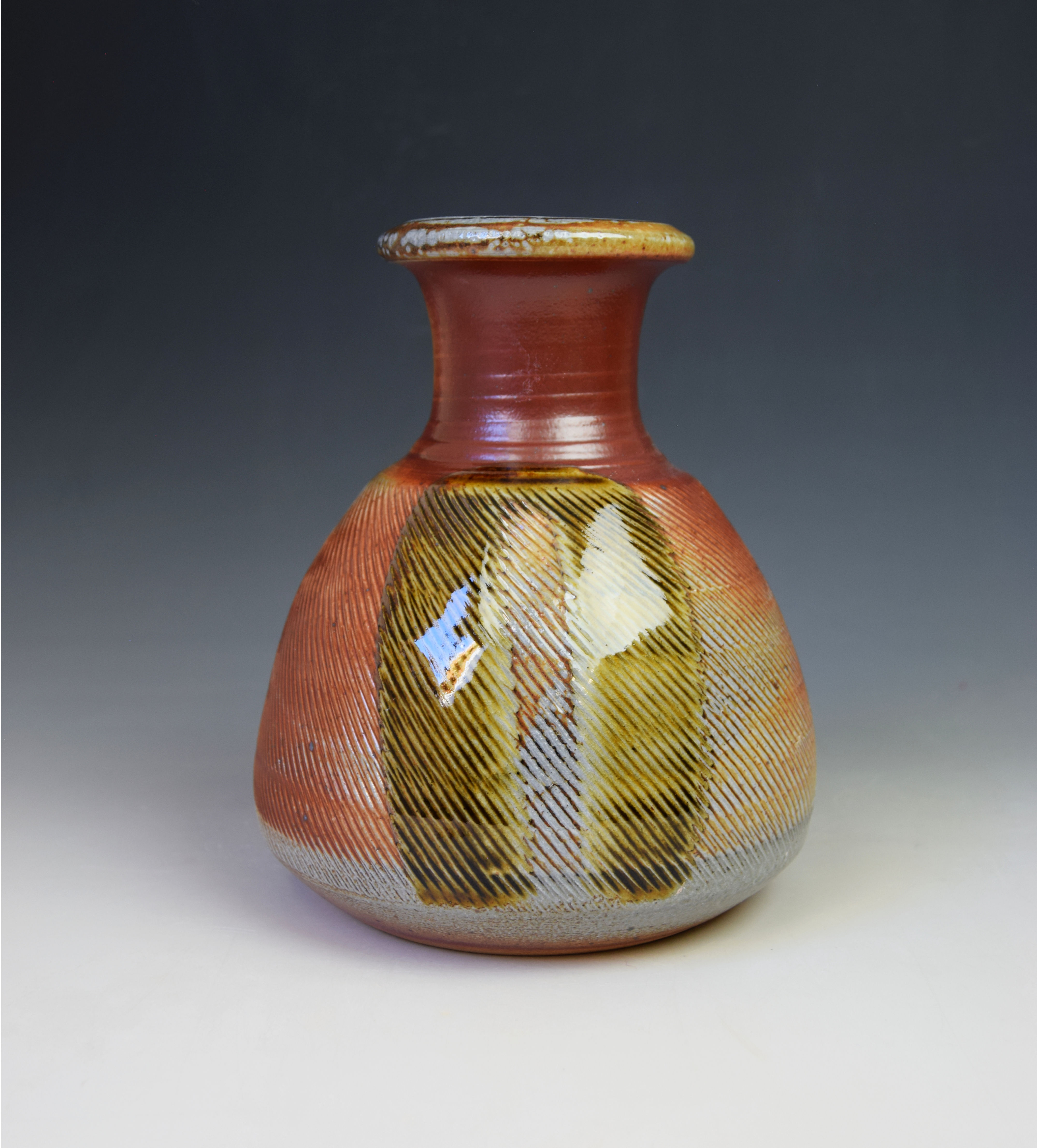 Soda fired bottle vase with poured decoration