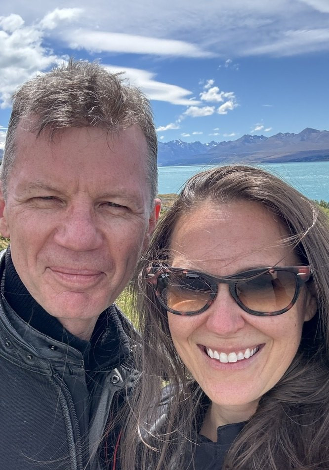 Jen and her partner Jon in riding jackets at Lake Pukaki on the South Island of New Zealand.