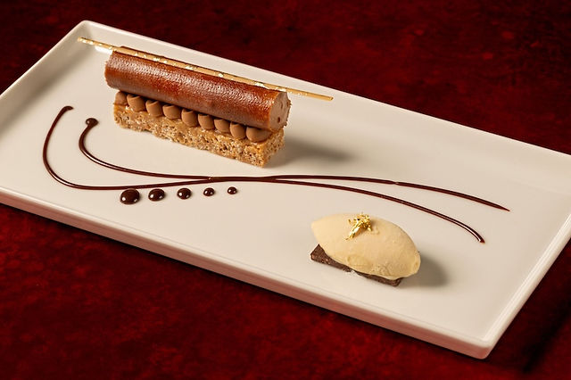 Disneyland Napa Rose fine dining dessert featuring a plated chocolate and mousse pastry with artistic sauce drizzle and gold-accented garnish, showcasing elegant Michelin-recognized dessert presentation at Disneyland Resort.