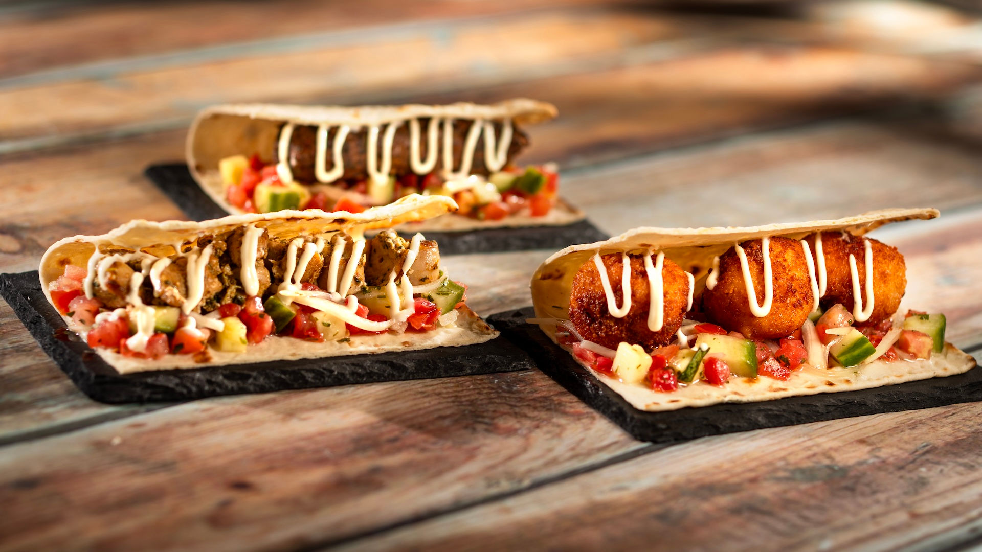 Savory festival flatbread slices with toppings and sauce drizzle from EPCOT Flower & Garden Festival booth, featuring shareable Disney World festival food and World Showcase Outdoor Kitchen specialties included in a Walt Disney World trip planning guide by Disney travel advisor Brandi Parker.