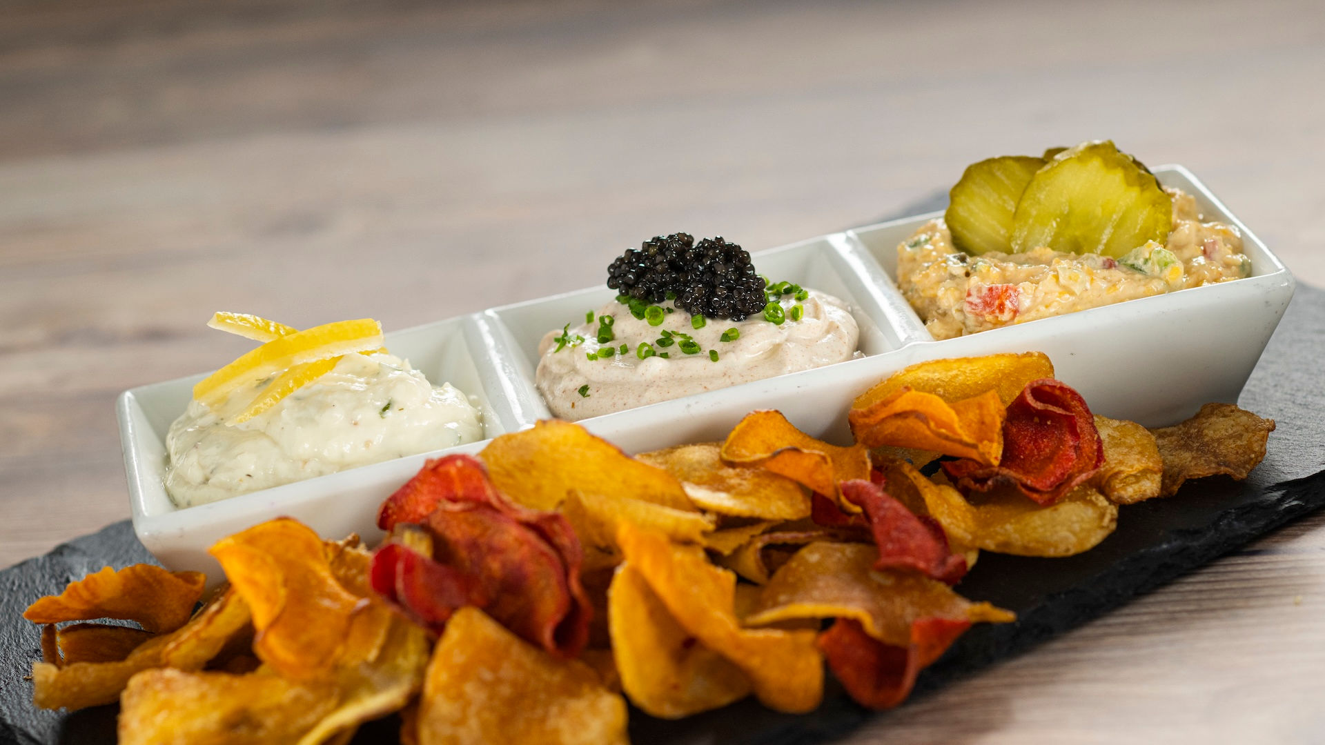 House-made potato chips with assorted gourmet dips and caviar-style topping from EPCOT International Flower & Garden Festival Outdoor Kitchen at Walt Disney World, featuring shareable Disney festival snacks and personalized Disney vacation planning expertise from Brandi Parker.