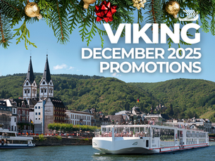 Holiday-themed promotional graphic for Viking Cruises showing a modern white Viking river ship sailing along a European river with lush green hills, medieval-style buildings, and twin-spire architecture in the background. Evergreen branches with gold and red ornaments frame the top of the image. Bold text reads “Viking December 2025 Promotions.” © Viking Cruises.