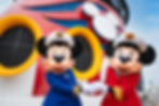 Captain Mickey and Captain Minnie standing together on a Disney Cruise Line deck in front of the iconic red funnel.