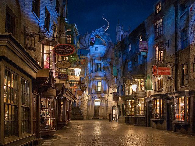 Diagon Alley at Universal Orlando lit at night during Halloween Horror Nights, showcasing the immersive Wizarding World atmosphere and Harry Potter and the Escape from Gringotts area open during the event.