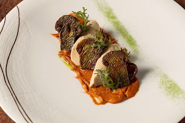 Disneyland Napa Rose fine dining entrée featuring an artfully plated gourmet dish with seared vegetables, creamy sauce, and herb garnish, highlighting upscale Michelin-recognized cuisine and signature dining at Disneyland Resort.