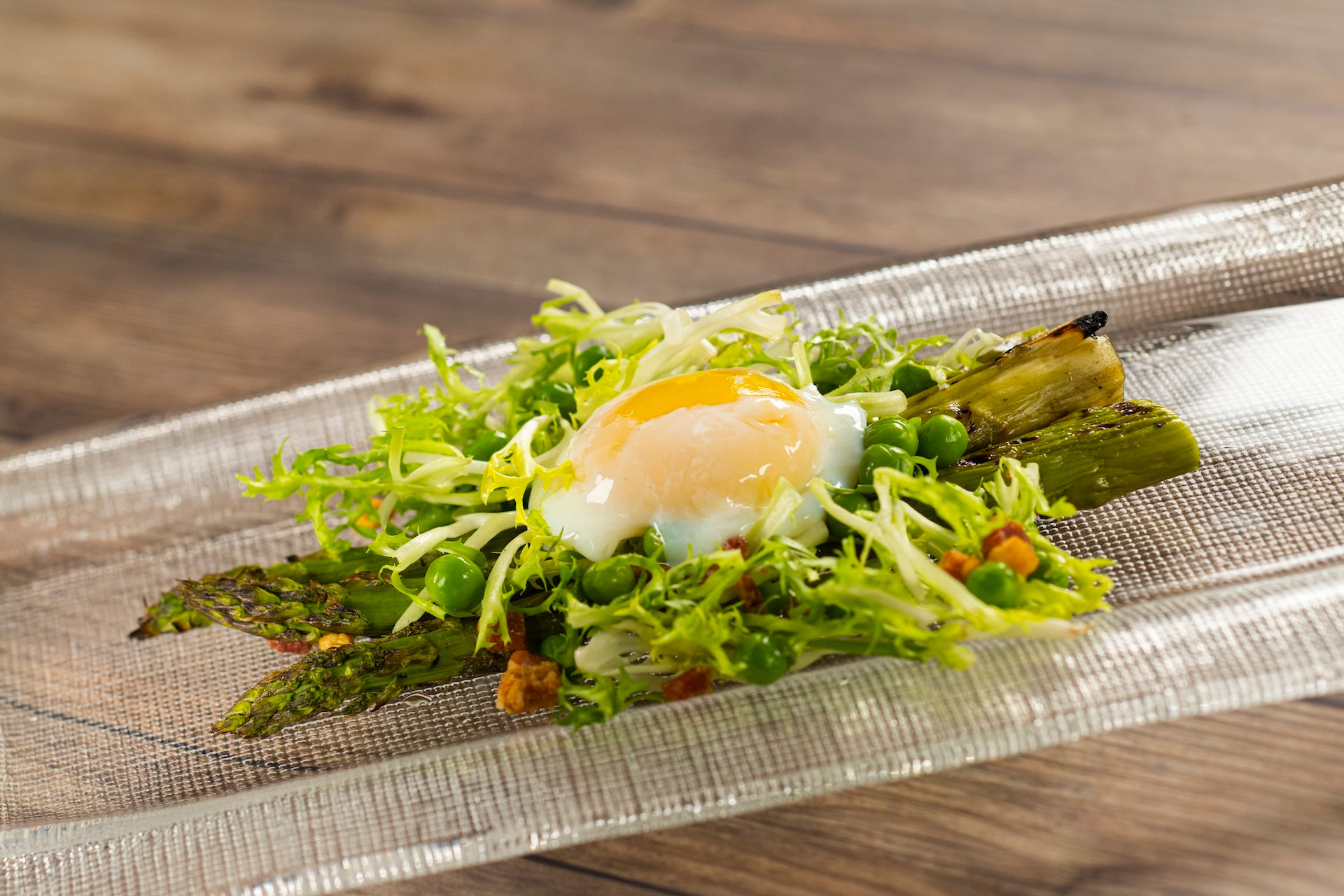 Grilled asparagus with greens and soft-poached egg from EPCOT International Flower & Garden Festival Outdoor Kitchen at Walt Disney World, showcasing seasonal festival dishes and curated food picks recommended by Disney vacation specialist Brandi Parker.