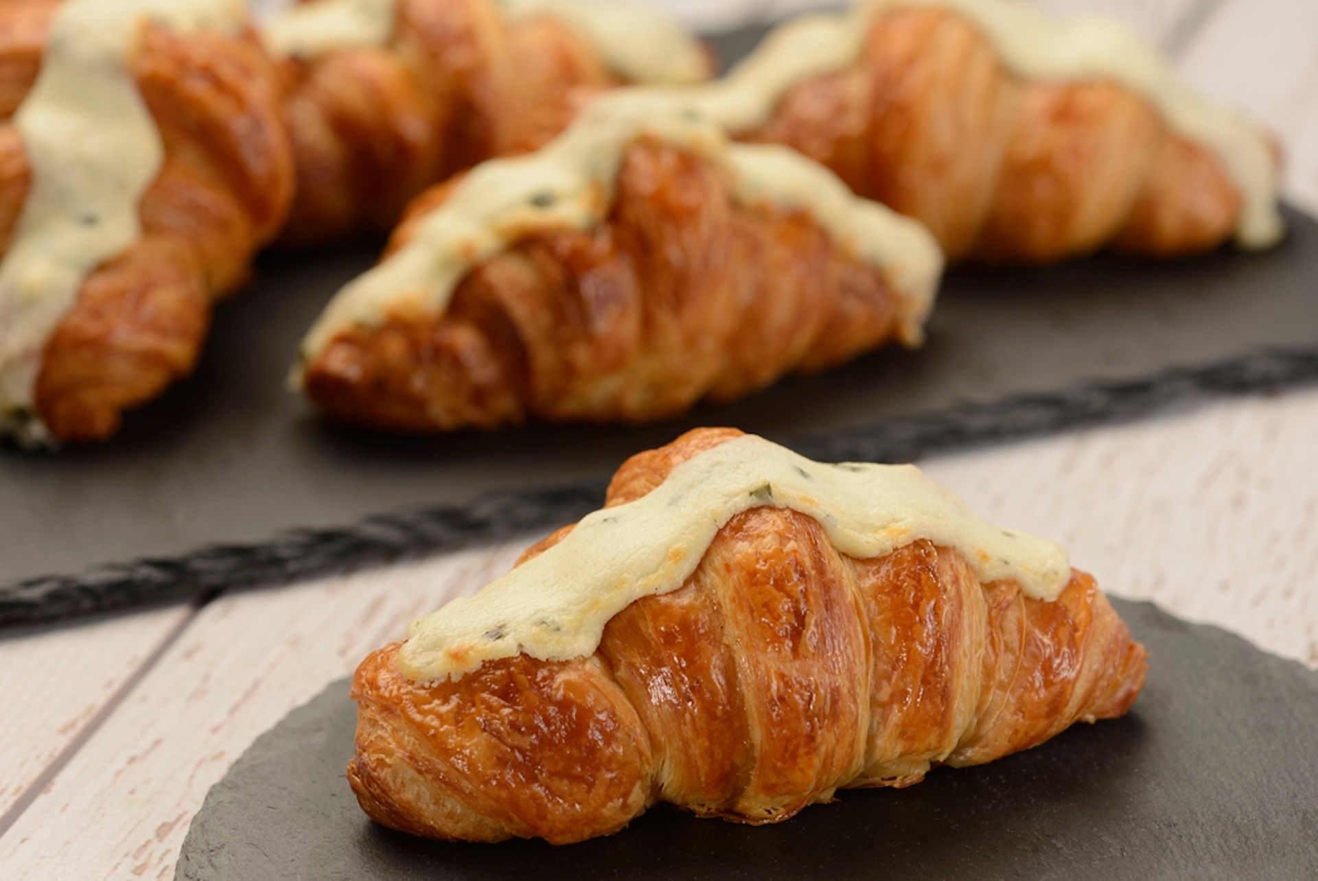 Fresh baked croissants topped with creamy glaze from EPCOT International Flower & Garden Festival Outdoor Kitchen, representing popular festival pastries and seasonal Disney snacks included in a Walt Disney World foodie strategy curated by travel planner Brandi Parker.