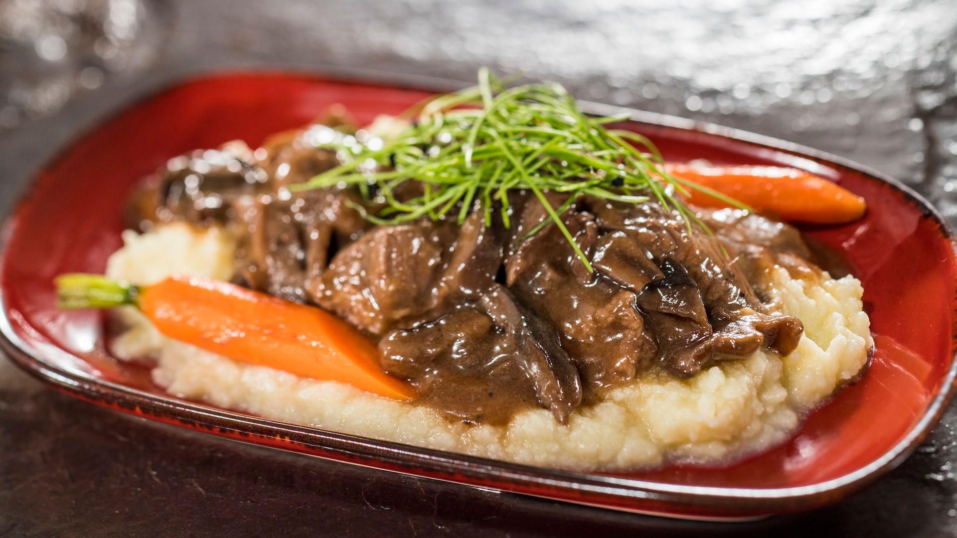 “Beef tenderloin tips with mushroom sauce over mashed potatoes at EPCOT Flower and Garden Festival, hearty Walt Disney World festival food option highlighted in Disney trip planning guidance from specialist Brandi Parker.”