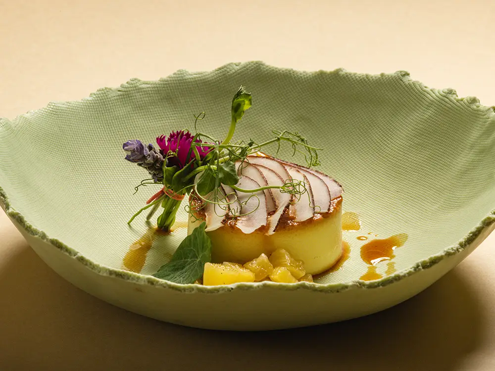 Refined plated dish at La Casa de la Playa showcasing elevated Mexican cuisine with delicate garnishes and fine dining presentation in an ultra-luxury resort setting.
