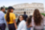 Family enjoying an Adventures by Disney guided tour of the Colosseum in Rome, Italy, with kids smiling while exploring historic ancient landmarks and immersive cultural experiences on a family-friendly European vacation.