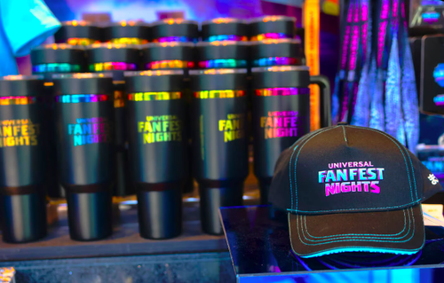 Universal Fan Fest Nights merchandise display featuring branded tumblers and hat at Universal Studios Hollywood event.