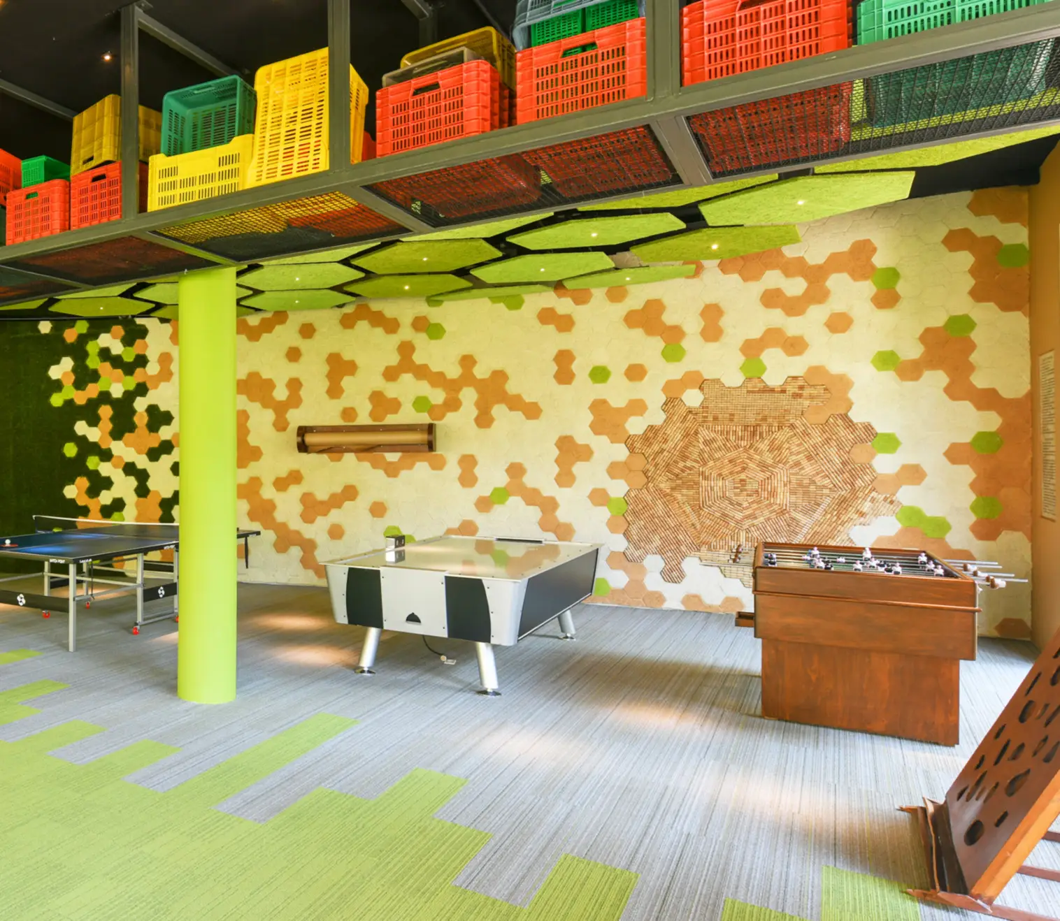 Hotel Xcaret Mexico recreation room with ping pong, air hockey, and foosball tables under vibrant ceiling design, highlighting family-friendly amenities, indoor entertainment, and all-inclusive resort experiences in Riviera Maya.