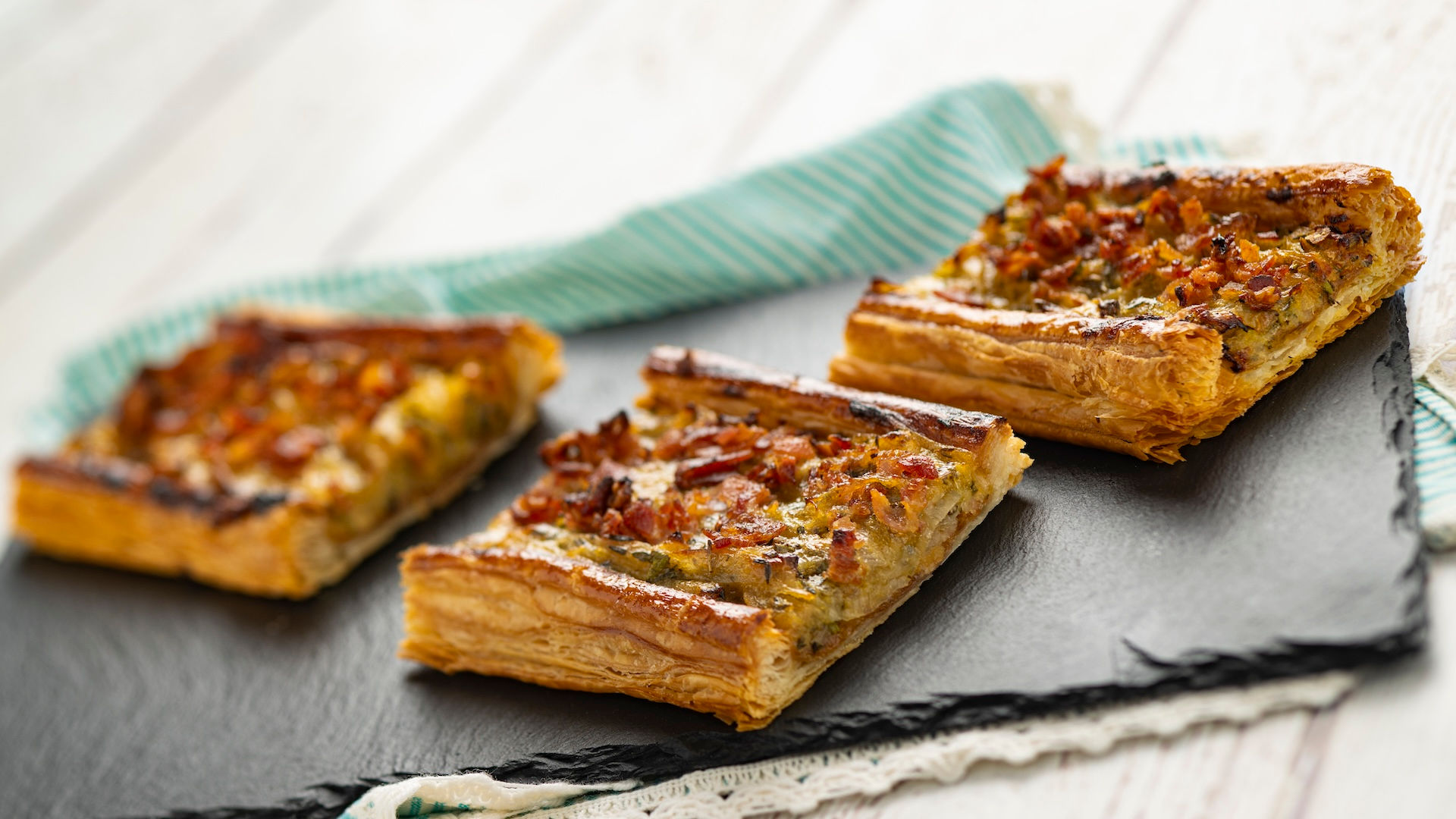 Savory vegetable tart squares served at EPCOT International Flower & Garden Festival Outdoor Kitchen, featuring seasonal Disney festival cuisine from World Showcase booths, highlighted in a Walt Disney World festival foodie planning guide by travel specialist Brandi Parker.