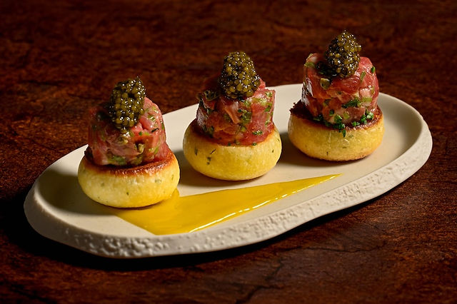 Upscale appetizer at Disneyland Napa Rose restaurant featuring beef tartare topped with caviar on brioche rounds, showcasing Michelin-recognized fine dining cuisine at Disneyland Resort.
