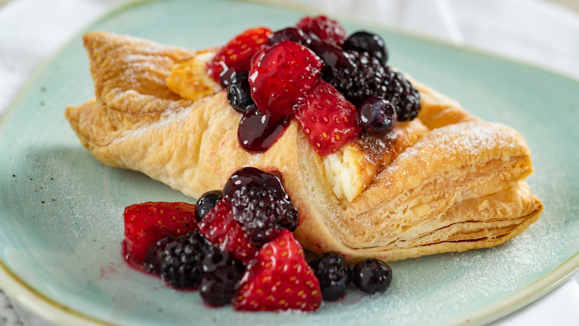 Flaky pastry filled with cream and topped with fresh berries served at EPCOT International Flower & Garden Festival.