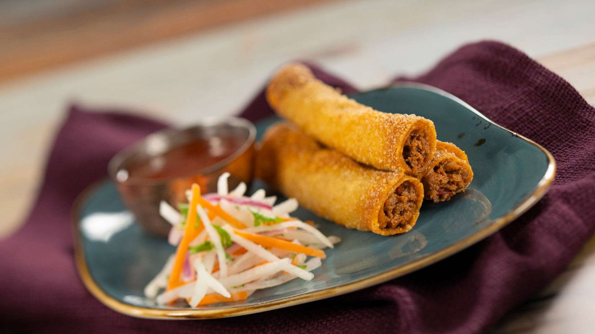 “Crispy festival spring rolls with fresh slaw at EPCOT International Flower and Garden Festival Outdoor Kitchen, highlighting global snack options and Disney food planning tips from Brandi Parker, Walt Disney World vacation specialist.