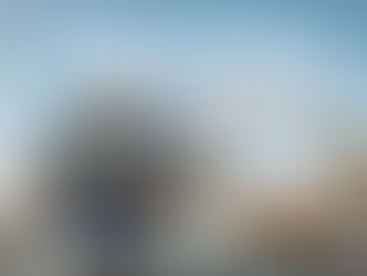 Promotional image of Universal Orlando Resort featuring the iconic rotating Universal globe fountain at the park entrance, surrounded by palm trees and theme park architecture under a bright blue sky. Large overlay text reads “Universal Orlando February Promos,” highlighting limited-time Universal Orlando vacation deals. The image represents Universal Orlando Resort theme park vacations, including Universal Studios Florida, Universal Islands of Adventure, immersive attractions, on-site hotels, and expertly planned Universal vacations by Brandi Parker of Magical Moments Vacations.