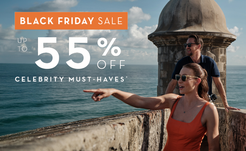 A couple explores the historic fortress walls overlooking the Caribbean Sea during a Celebrity Cruises vacation. The woman in an orange sundress points excitedly toward the horizon while the man behind her smiles, taking in the coastal views. The scene captures bright sunlight, turquoise ocean water, and the stone watchtower architecture iconic to Old San Juan, Puerto Rico. The promotional overlay reads: “Black Friday Sale – Up to 55% Off Celebrity Must-Haves.” This travel marketing image highlights luxury cruising, tropical destinations, and limited-time cruise deals.