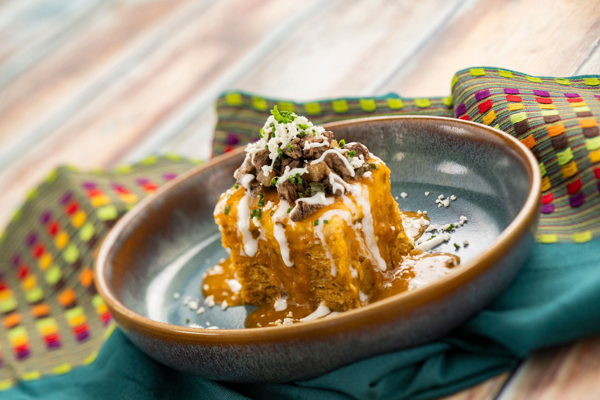 Sweet festival dessert topped with icing drizzle and crumble, served at EPCOT International Flower & Garden Festival