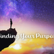 A silhouette of a person standing on a cliff edge at sunset, looking up into a vibrant, star-filled sky. The text “Finding Your Purpose” overlays the image, suggesting introspection and connection to something greater.