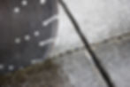 Close up showing a concrete cutter blade cutting into a concrete driveway.jpg
