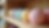 Eye-level view of neatly arranged bath bombs on a wooden shelf