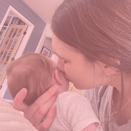 Mother kissing her new baby