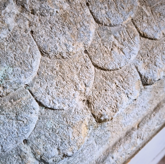 Close up of the shingle roof of the childs headstone