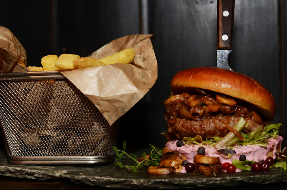 Gourmet burger with mushrooms, berries and french fries.