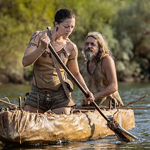Dr. Theresa Emmerich Kamper rowing a historical leather boat.