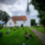 The white stone Norderhov church and graveyard in Ringerike Norway.