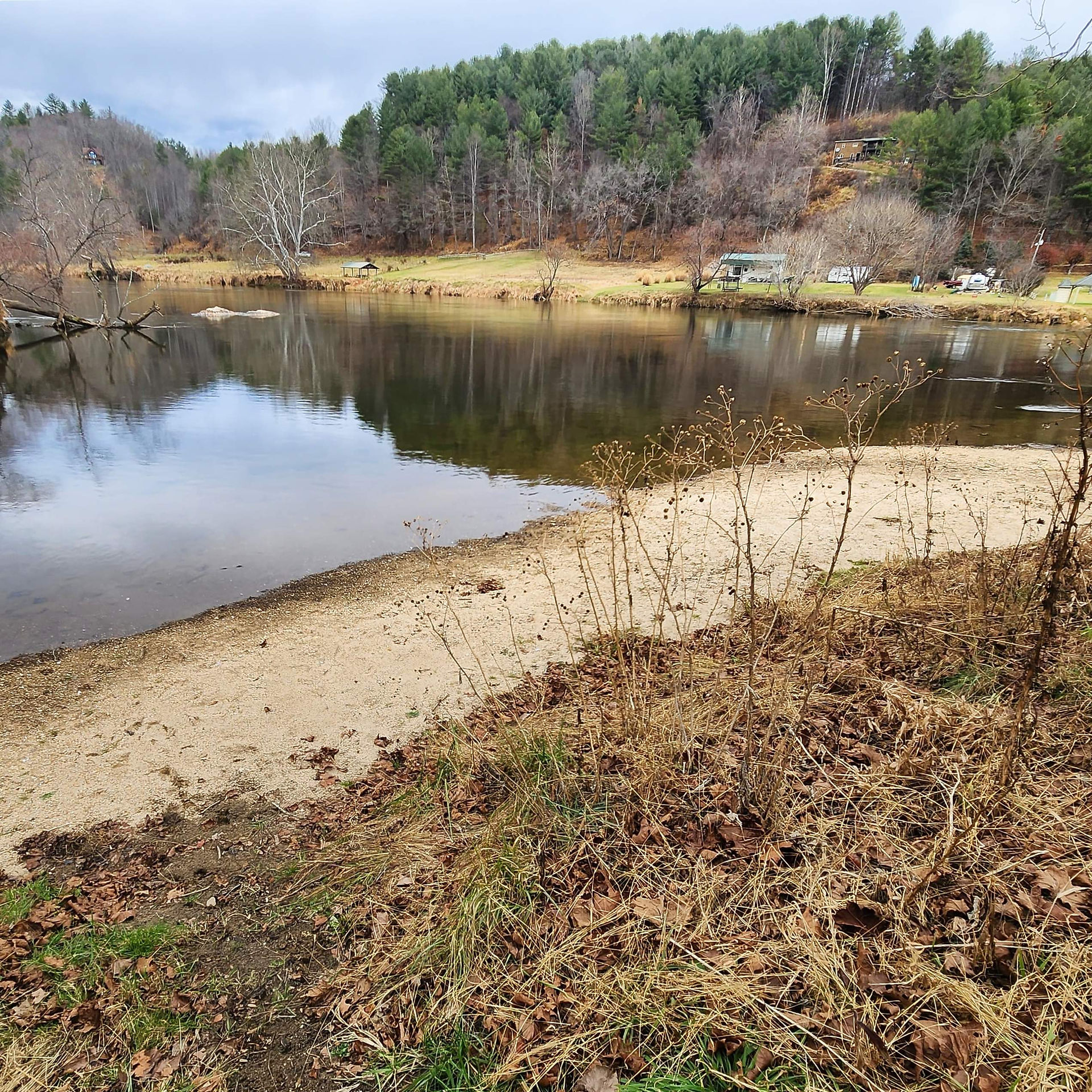 River with sandy bank and forested hills