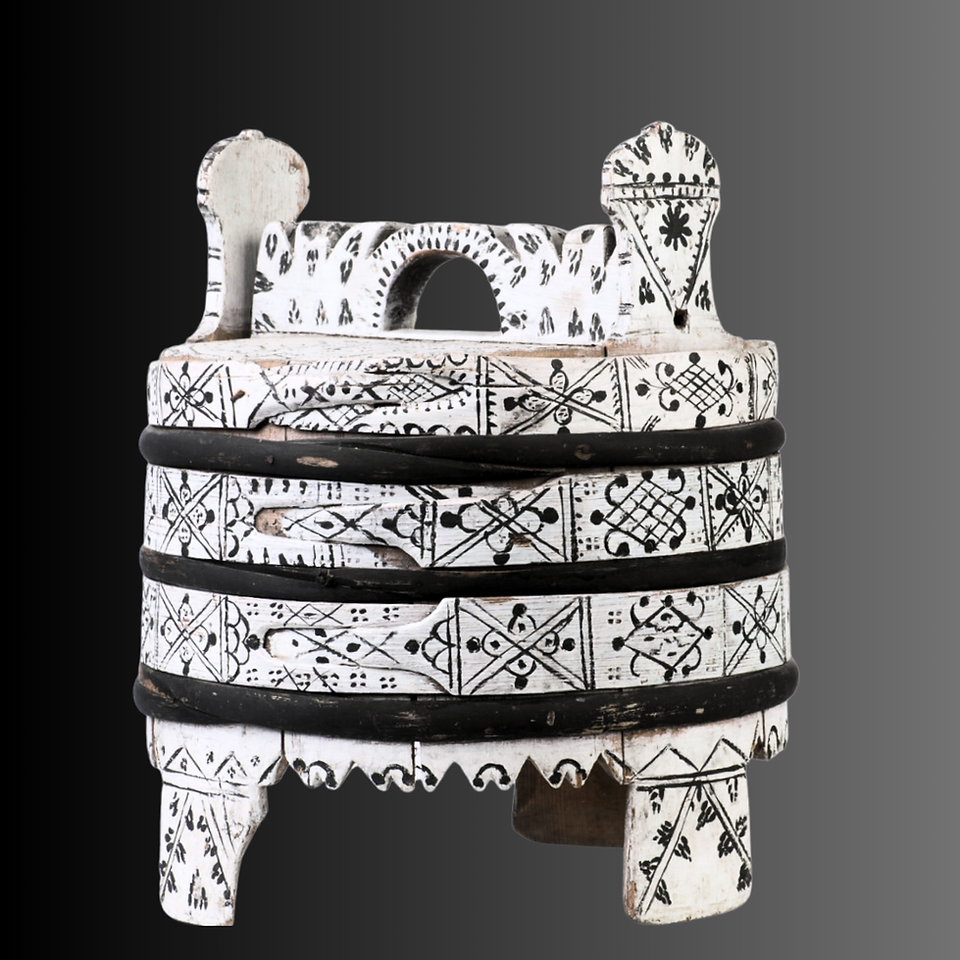 White wooden container called amber painted with black protection symbols. It stands on three legs. Black gradient background. 