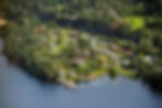 Utvika Camping by Tyrifjorden with trees, lawn, pier, campers and cabins