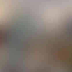 Woman processes deer skins, outdoor setting with wood fence and deer skin tanning.