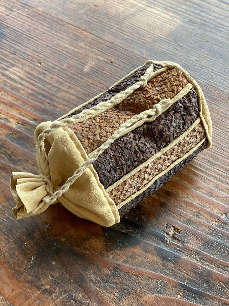 Handmade pouch crafted with unique brown fish skin, intricate design and texture.