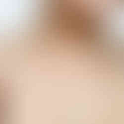 Women holding sheer fabric swatch against her skin.