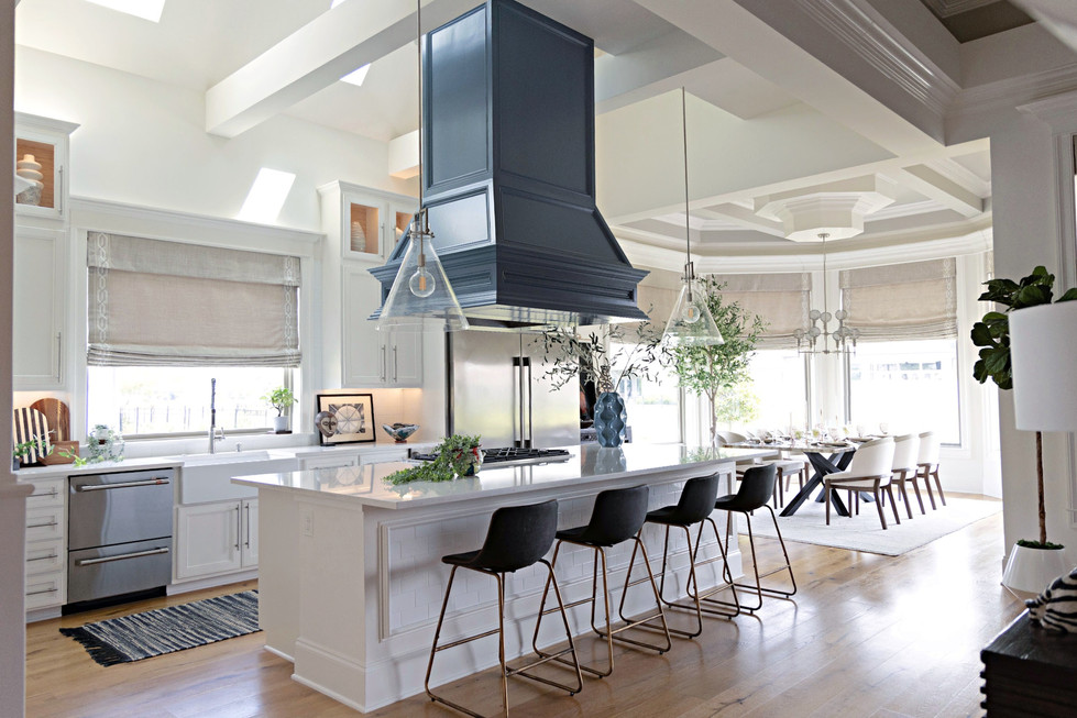 a kitchen with white cabinets and black stools